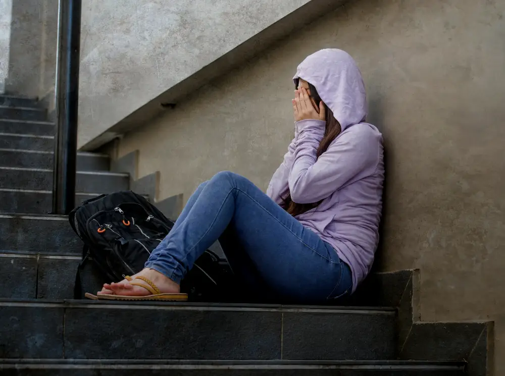 teen girl alone on stairs